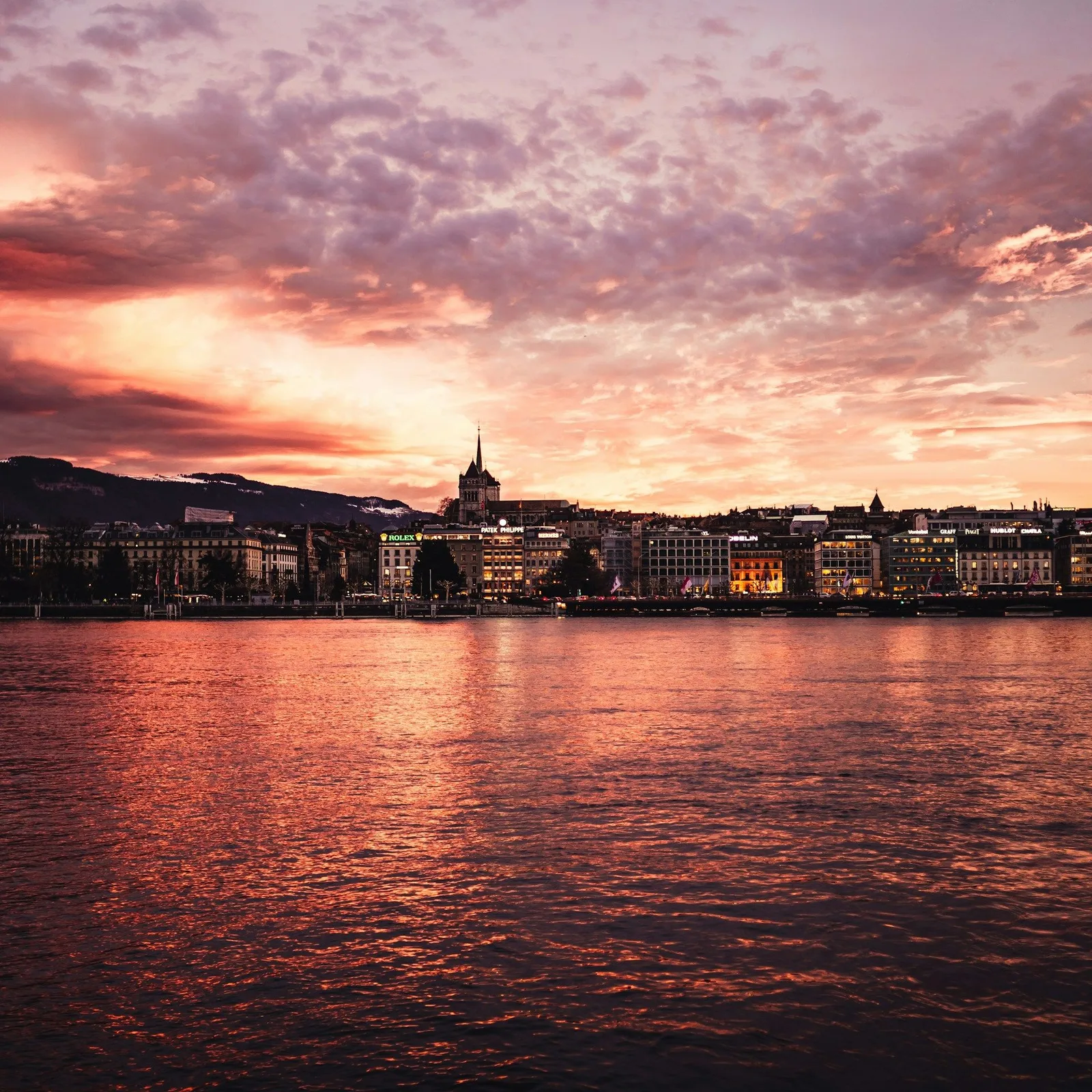 Skyline van de waterkant van Genève bij zonsondergang
