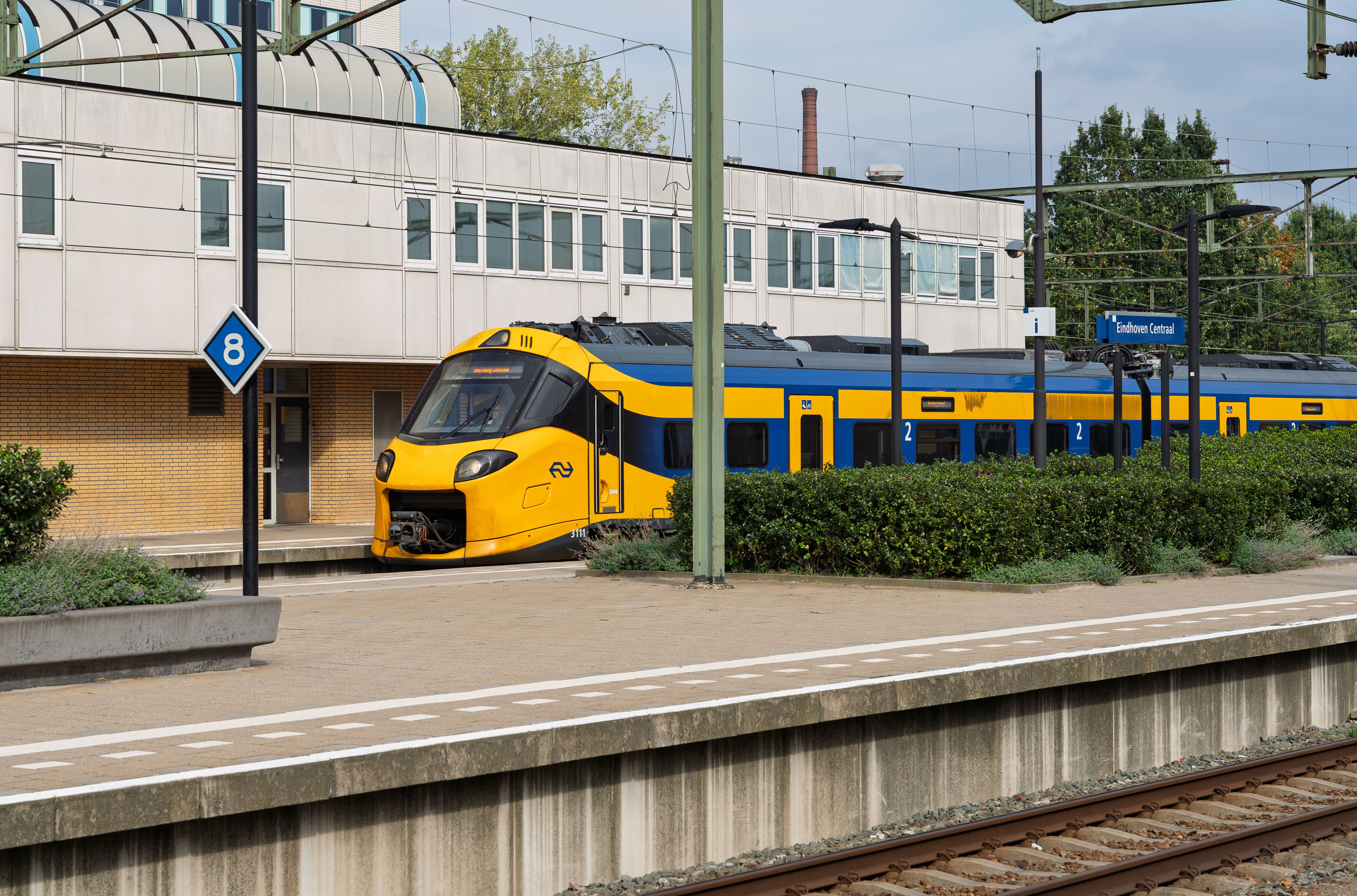 A yellow NS train at a platform in Eindhoven