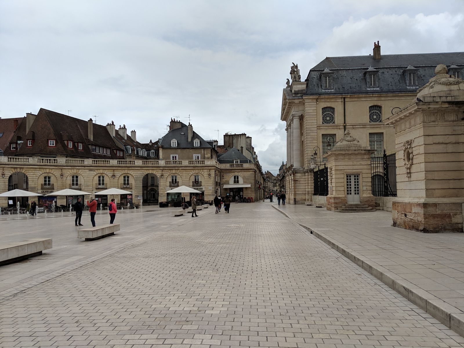 Place de la Libération in Dijon, framed by historic stone buildings.