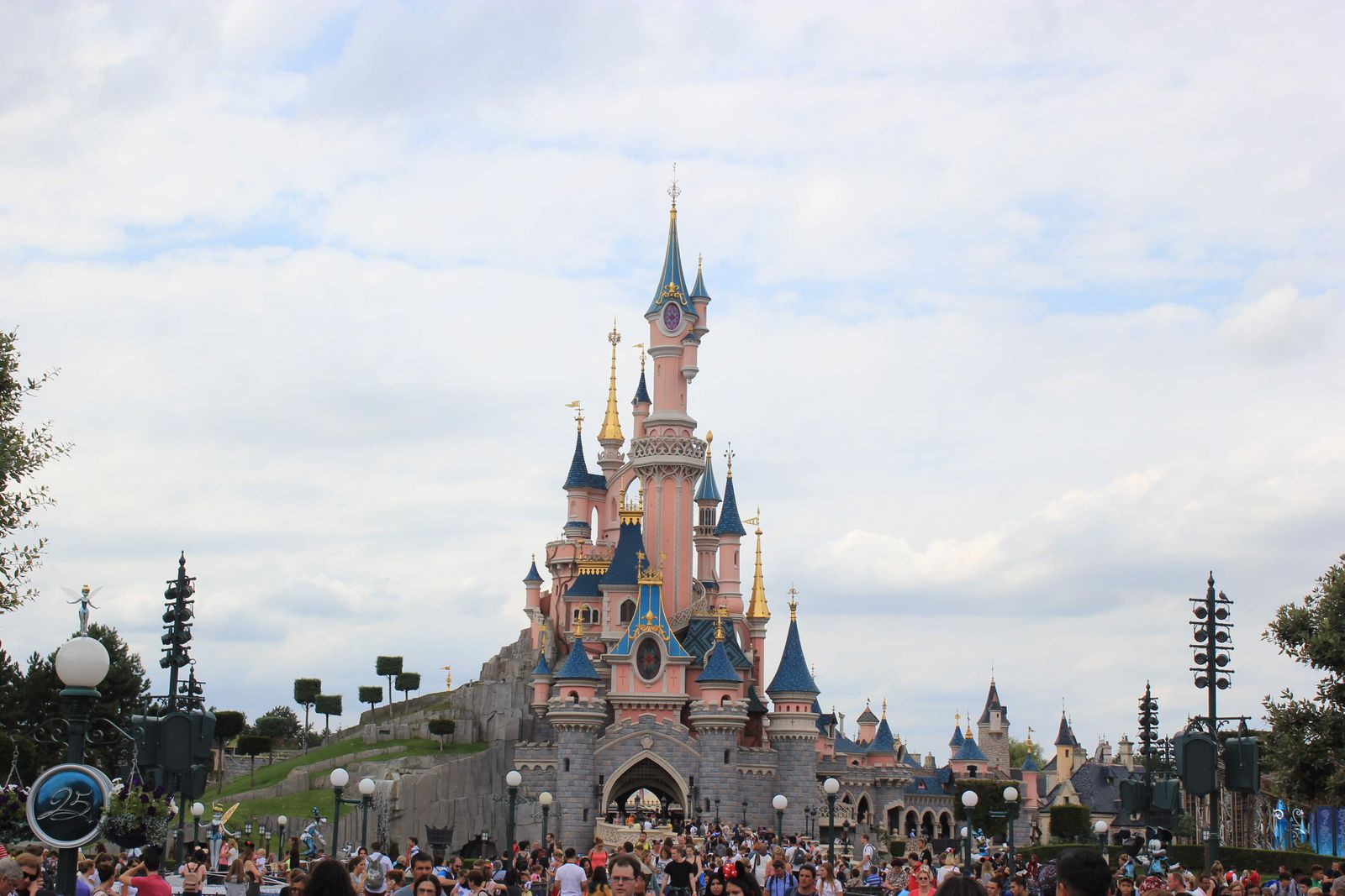 Sleeping Beauty Castle at Disneyland Paris with visitors in front.